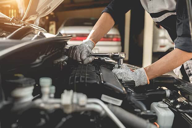 man repairing engine